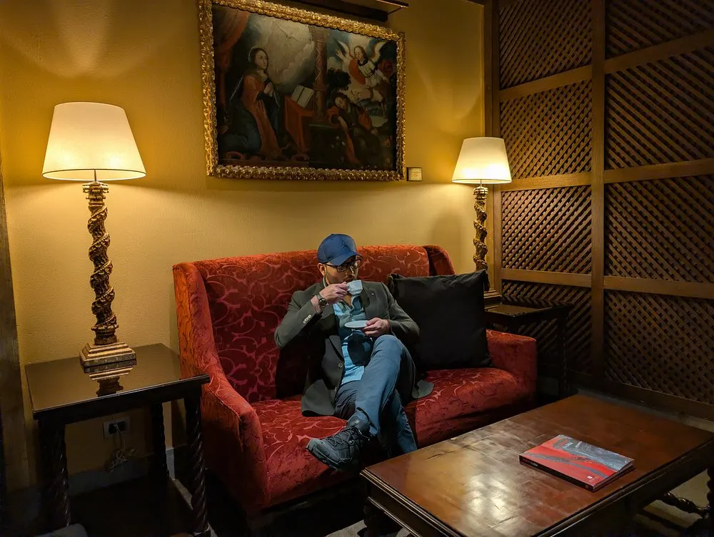 Guest relaxing in a cozy lounge at Palacio del Inka